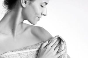 Kvinna som är insvept i en handduk.